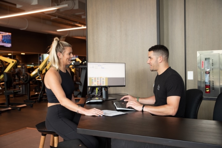 Woman signing up to be a member at fit athletic gym