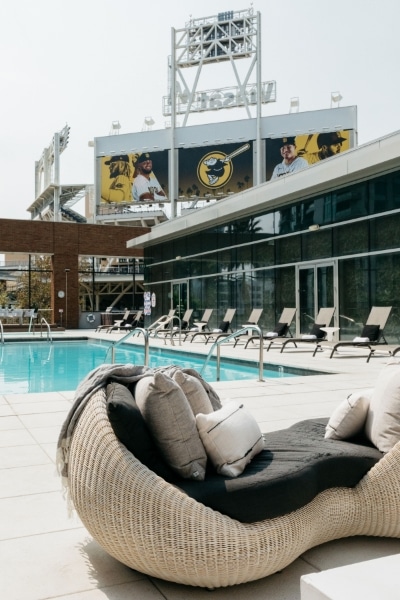 A woman is holding two pink dumbbells in her hands.