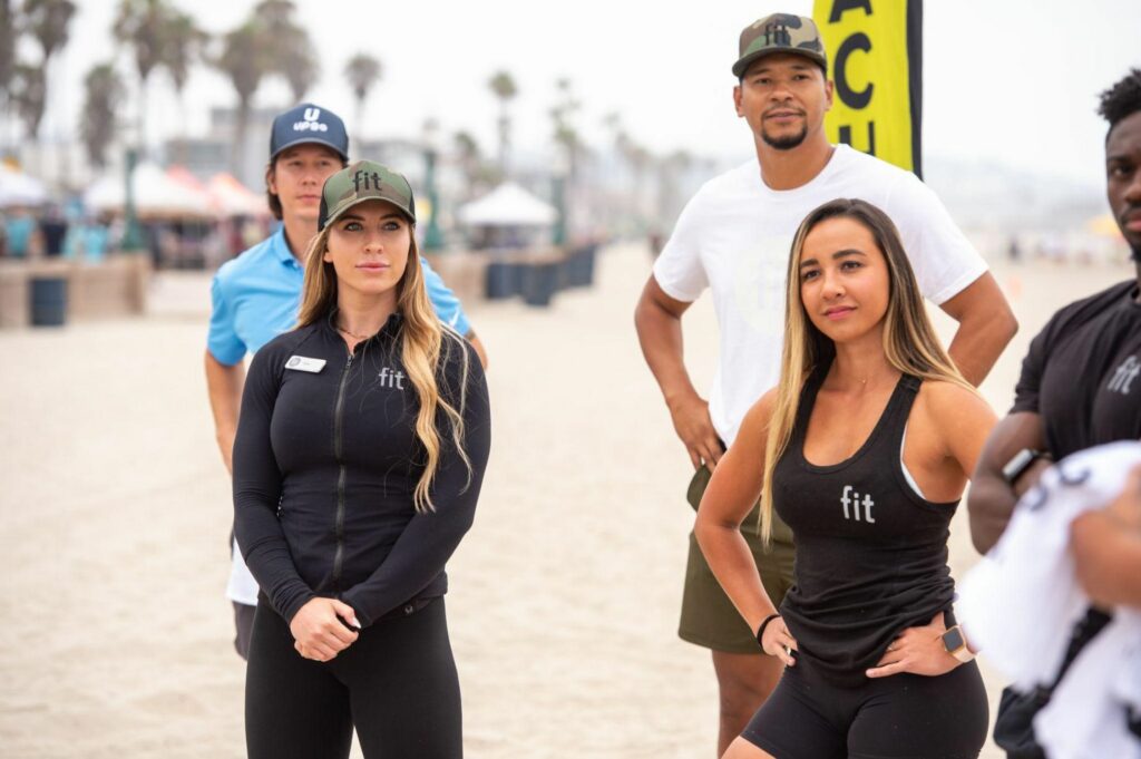 A group of people doing squats with heavy weights.