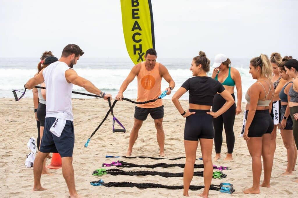 A group of people doing squats with heavy weights.