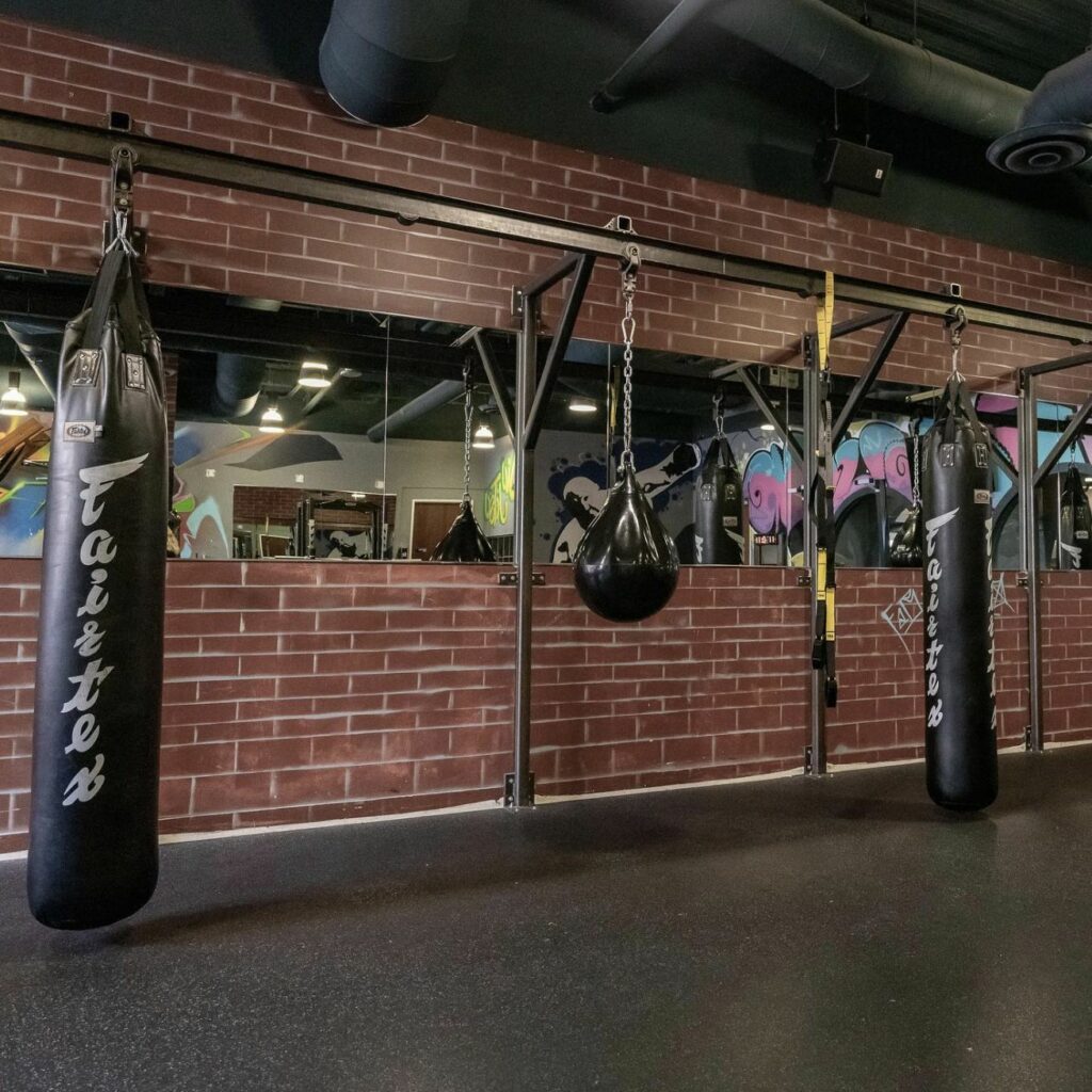 A gym with punching bags and punching bags.