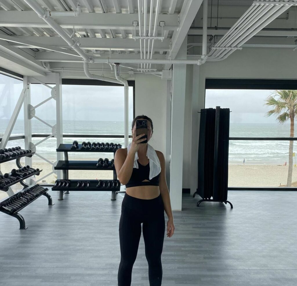 A woman taking a selfie in a gym.