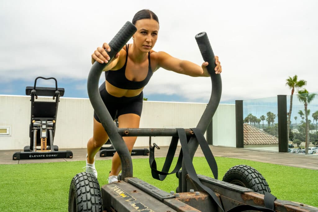 A woman is doing a push up on an exercise bike.