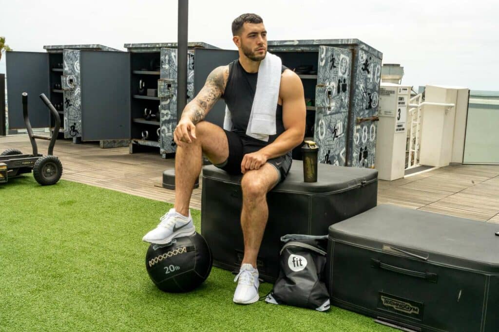 A man and woman running in a gym.