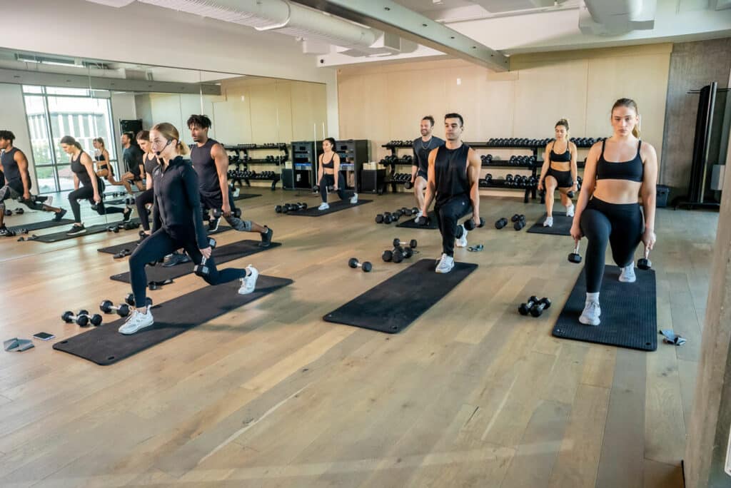 A group of women doing a workout in a gym.