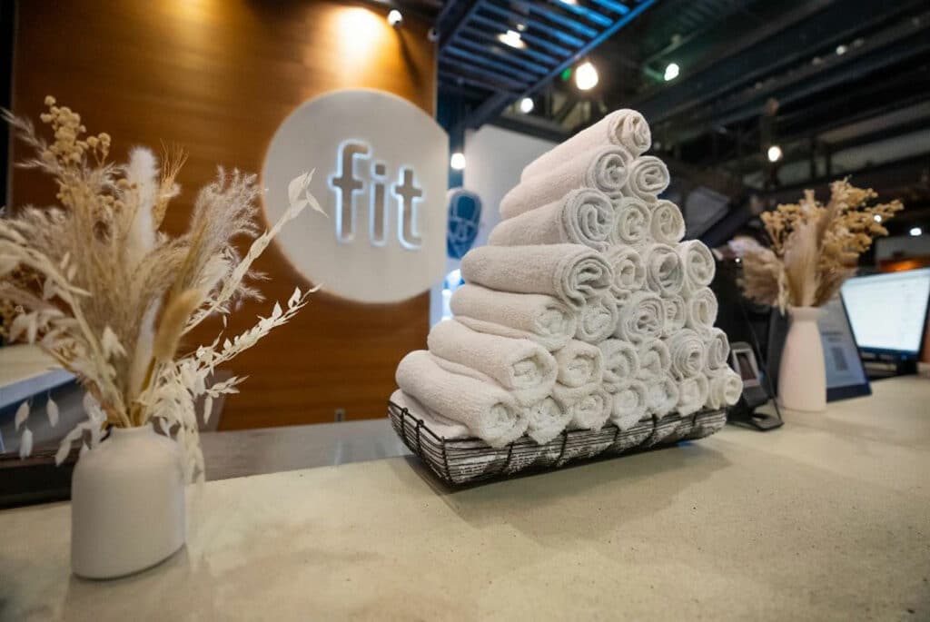 A stack of towels on a counter at a fitness center.