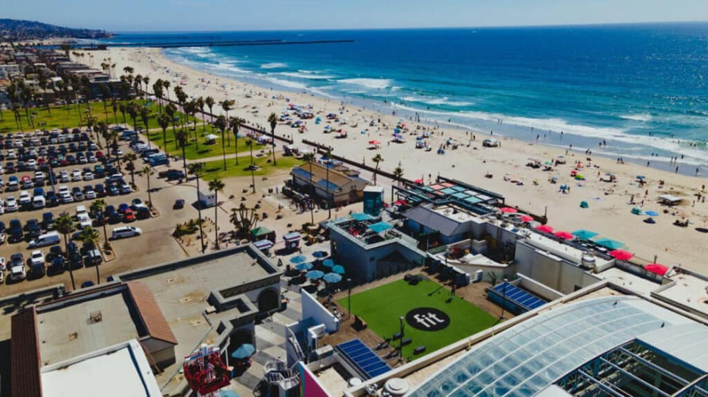 An aerial view of a beach and a parking lot.